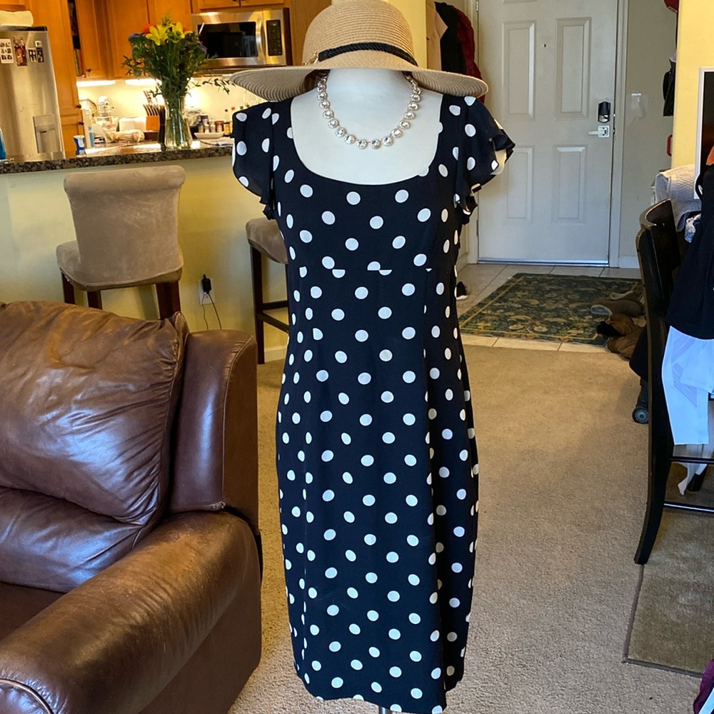 The limited black sheath dress with cream, polkadots and ruffle sleeve